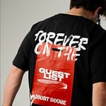 Black oversized T-shirt with bold 'Forever on the Guest List' graphic, red background, and streetwear design.