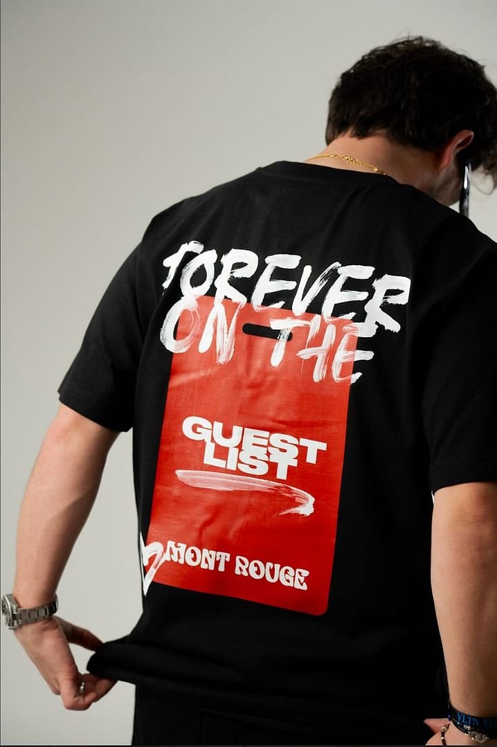 Black oversized T-shirt with bold 'Forever on the Guest List' graphic, red background, and streetwear design.