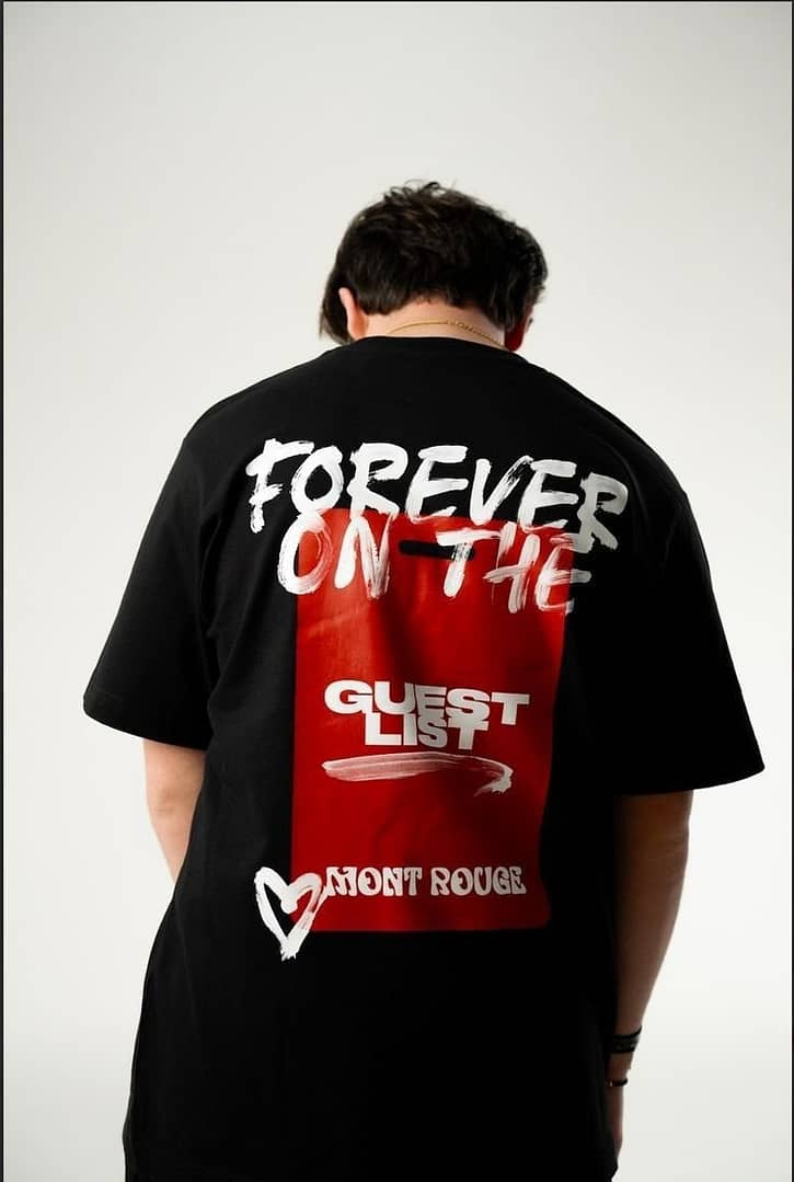 Black oversized T-shirt with bold 'Forever on the Guest List' graphic, red background, and streetwear design.